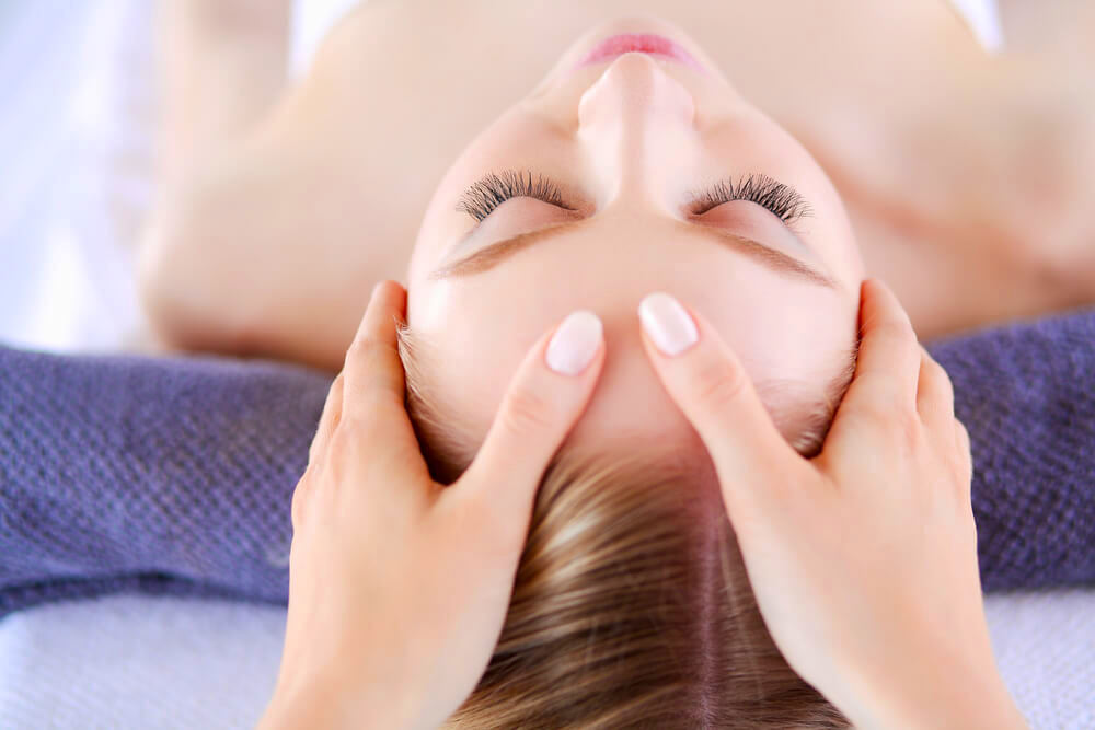 Woman enjoying a facial massage 