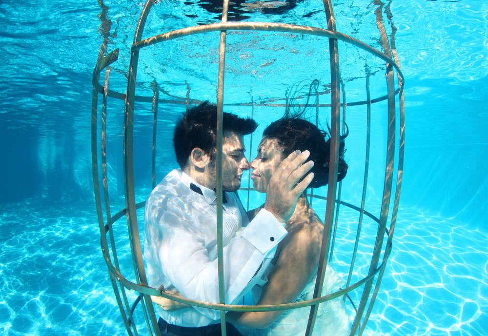 Couple celebrating an underwater wedding.