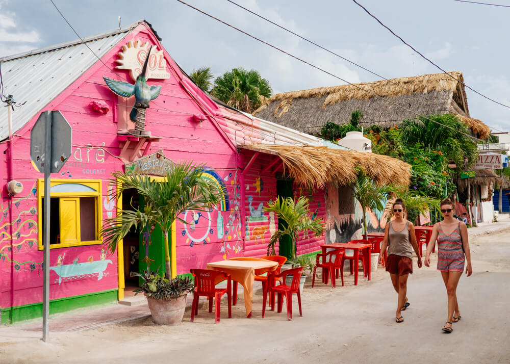 Tourists walk past a restaurant in the two of Isla Holbox, Mexico on Thursday, May 10, 2018.